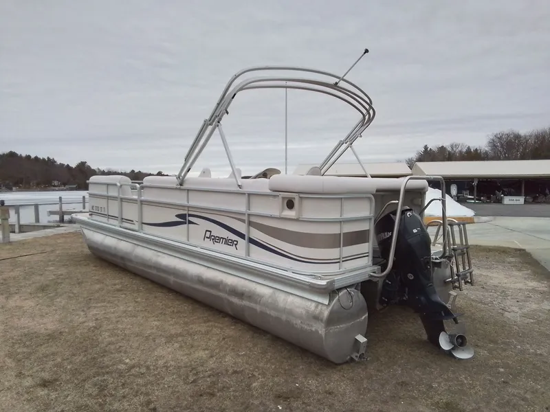 Slide: The Image of 2006 Premier 225 Sunsation pontoon boat parked on shore. - 6