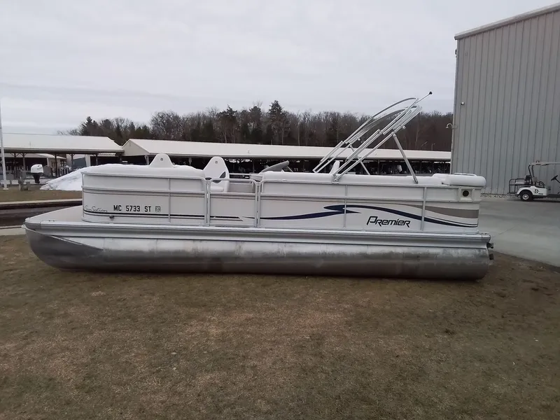 Slide: The Image of 2006 Premier 225 Sunsation pontoon boat parked on grass. - 7