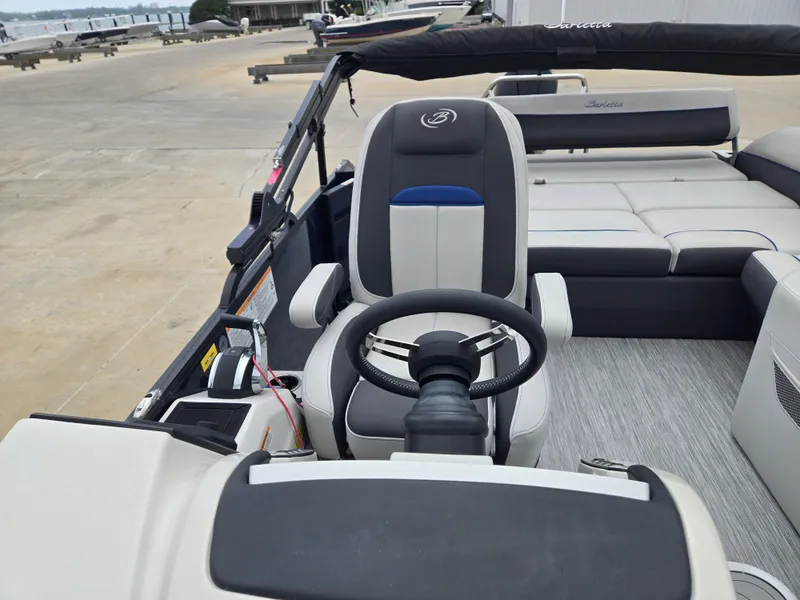 Slide: The Image of Interior of a 2021 Barletta 23U CORSA boat with steering and seating. - 7