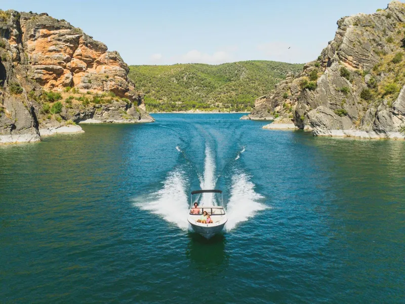 Slide: The Image of Bayliner V20i 2026 cruising through scenic canyon. - 6