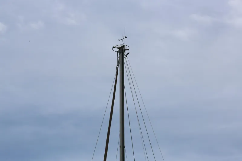 Slide: The Image of Mast of 1994 Island Packet 35 sailboat against cloudy sky. - 10
