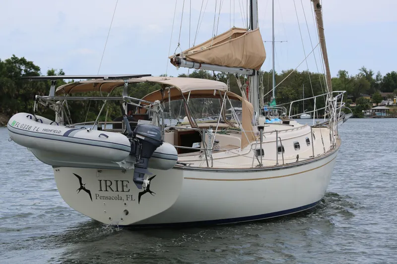 Slide: The Image of Sailing yacht Island Packet 35, 1994 model, cruising in Pensacola waters with dinghy attached. - 12
