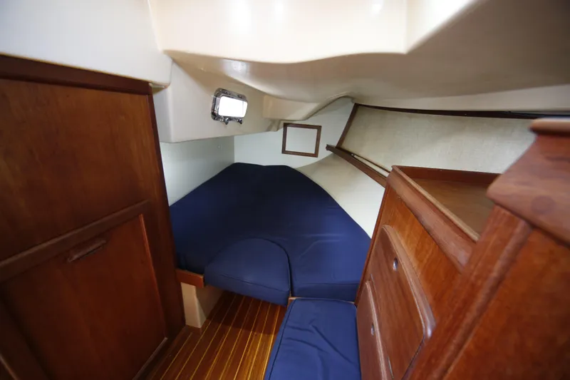 Slide: The Image of Cozy cabin interior of 1994 Island Packet 35 sailboat with wooden furnishings. - 25