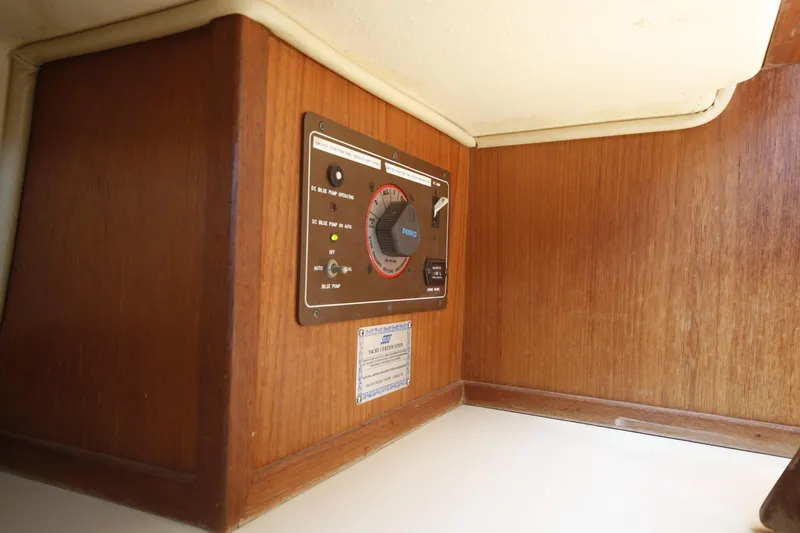 Slide: The Image of 1994 Island Packet 35 yacht interior with control panel and wooden finish. - 31