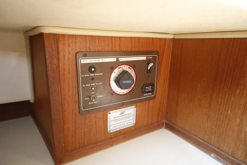 Slide: The Image of Control panel on a 1994 Island Packet 35 yacht, featuring bilge pump and battery switches. - 32