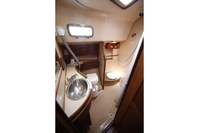 Slide: The Image of 1994 Island Packet 35 yacht bathroom with sink, toilet, and shower. - 34