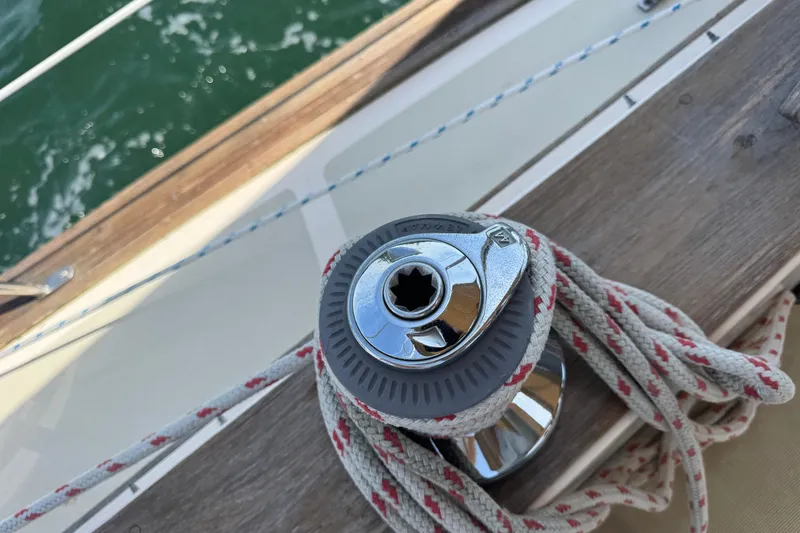 Slide: The Image of Winch and rope on 1994 Island Packet 35 sailboat deck, near water. - 41
