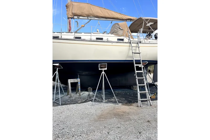 Slide: The Image of 1994 Island Packet 35 sailboat on dry dock with ladder and supports. - 45