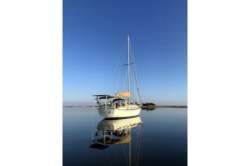 Slide: The Image of Sailboat Island Packet 35, 1994 model, anchored on calm water under clear blue sky. - 48