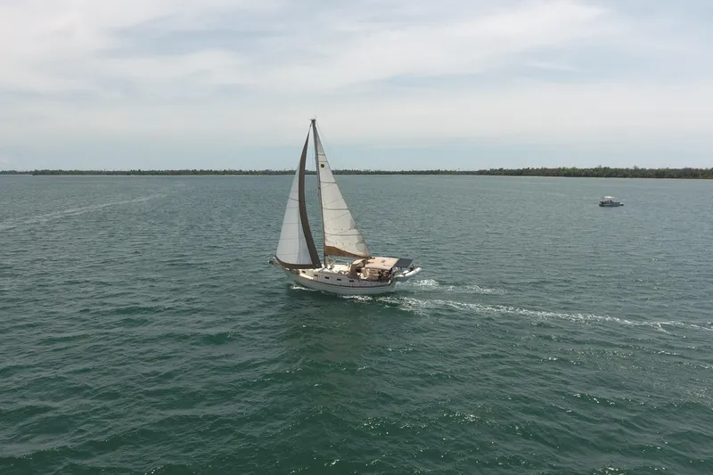 Slide: The Image of Sailboat Island Packet 35 (1994) cruising on open water under clear skies. - 8