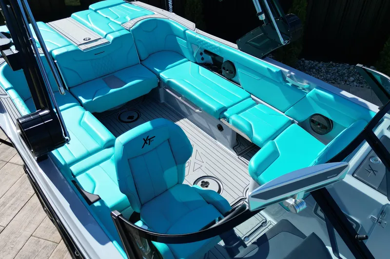 Slide: The Image of 2025 MasterCraft XT24 boat interior with turquoise seating and modern design. - 10