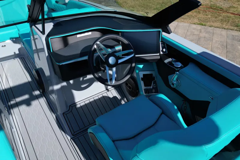 Slide: The Image of 2025 MasterCraft XT24 boat interior with modern dashboard and turquoise seating. - 11