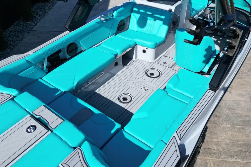 Slide: The Image of 2025 MasterCraft XT24 boat interior with turquoise seating and sleek design. - 4