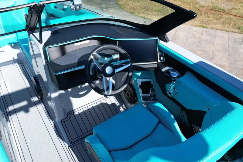 Slide: The Image of 2025 MasterCraft XT24 boat interior with modern steering and turquoise seating. - 5