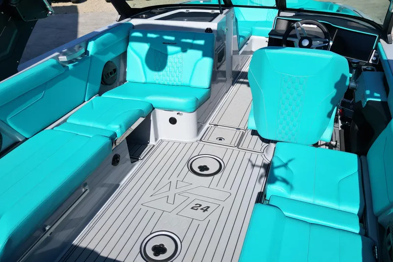 Slide: The Image of 2025 MasterCraft XT24 boat interior with turquoise seating and modern design. - 6