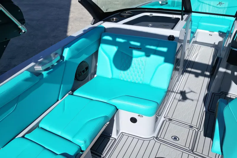 Slide: The Image of 2025 MasterCraft XT24 boat interior with turquoise seating and modern design. - 8