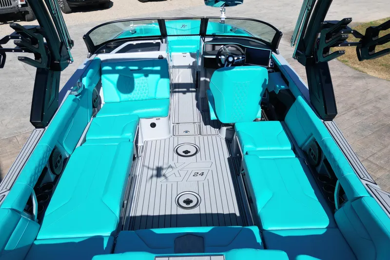 Slide: The Image of 2025 MasterCraft XT24 boat interior with turquoise seating and modern design. - 9