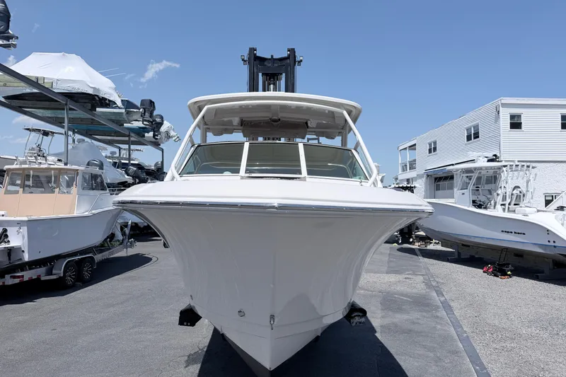 Slide: The Image of 2021 Sailfish 245 DC boat in a marina, surrounded by other vessels. - 22
