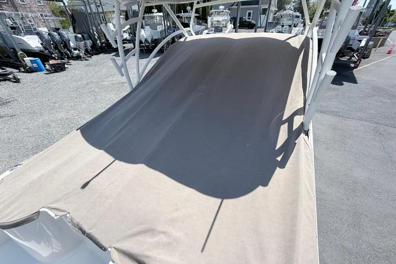 Slide: The Image of Covered 2021 Sailfish 245 DC boat in a storage area with other boats. - 26