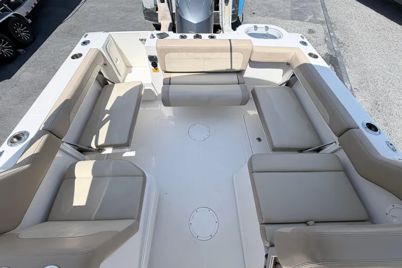 Slide: The Image of 2021 Sailfish 245 DC boat interior with beige seating and cup holders. - 28