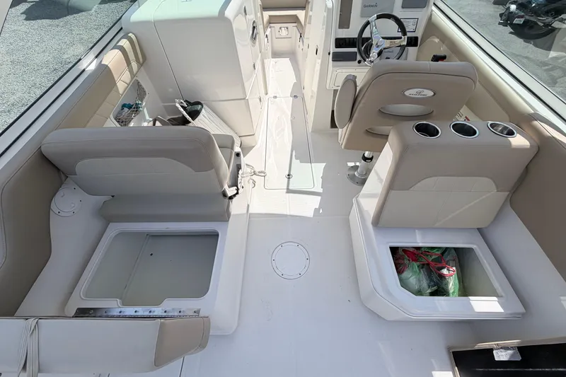 Slide: The Image of 2021 Sailfish 245 DC boat interior with seating, storage compartments, and steering console. - 30
