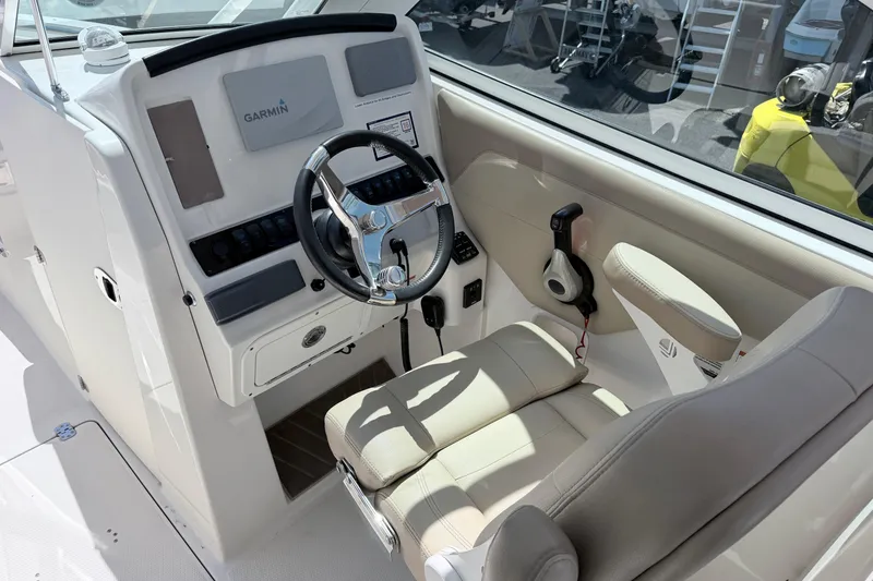 Slide: The Image of 2021 Sailfish 245 DC boat cockpit with Garmin navigation system and comfortable seating. - 32