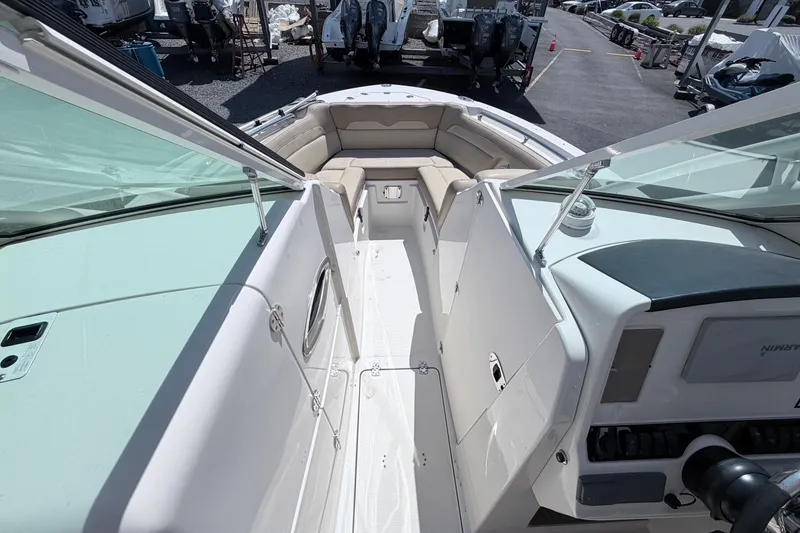 Slide: The Image of 2021 Sailfish 245 DC boat interior with seating and dashboard view. - 35
