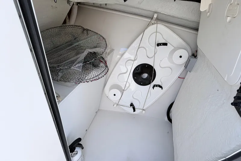 Slide: The Image of Interior storage of 2021 Sailfish 245 DC boat with fishing net and equipment. - 36