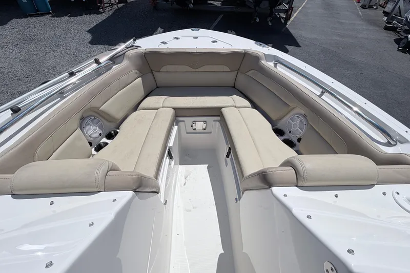 Slide: The Image of 2021 Sailfish 245 DC boat interior with beige seating and built-in speakers. - 38