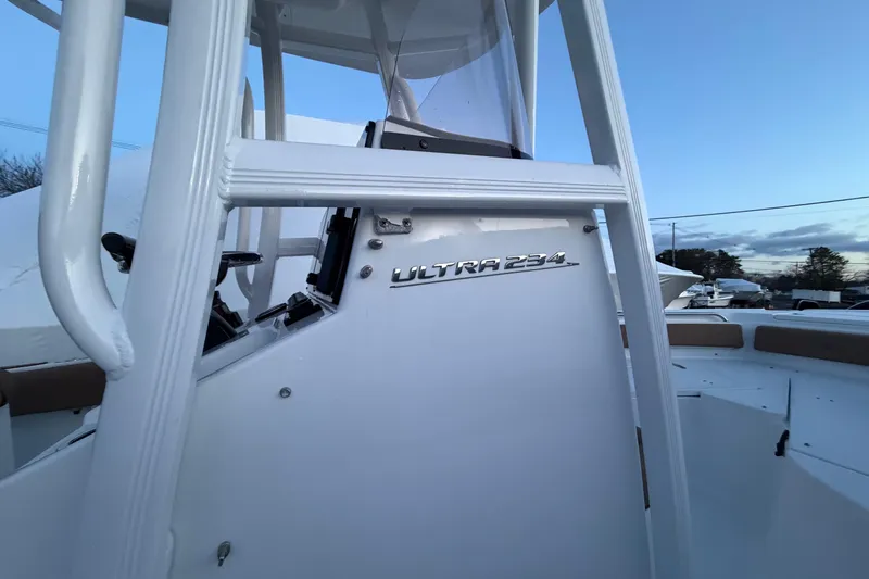 Slide: The Image of 2022 Sea Hunt Ultra 234 boat console with clear sky background. - 5
