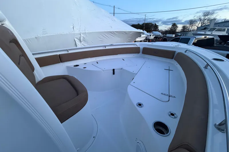 Slide: The Image of 2022 Sea Hunt Ultra 234 boat interior with cushioned seating and storage compartments. - 6