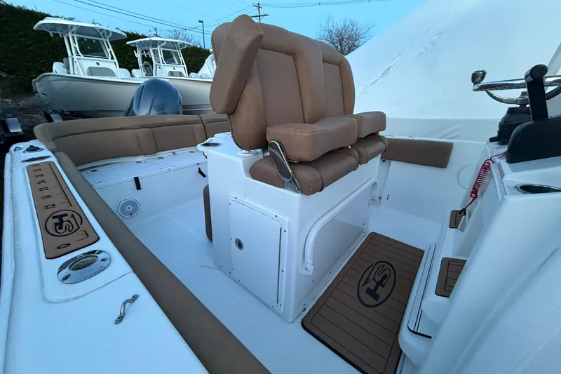 Slide: The Image of 2022 Sea Hunt Ultra 234 boat interior with tan seating and white deck. - 7
