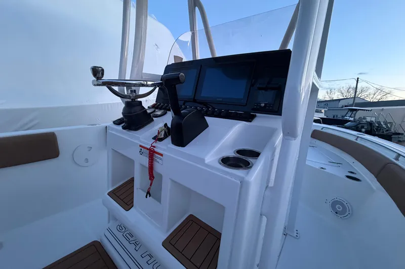 Slide: The Image of 2022 Sea Hunt Ultra 234 boat console with steering wheel and navigation display. - 8