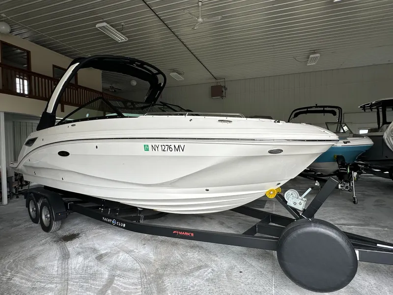 The Image of 2024 Sea Ray SDX 250 boat on trailer in storage facility. - 1