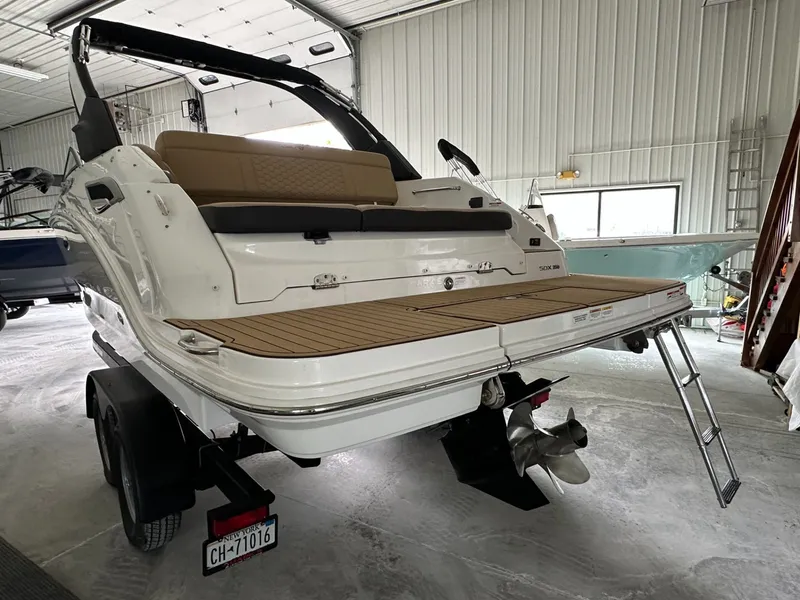 Slide: The Image of 2024 Sea Ray SDX 250 boat indoors on trailer. - 5
