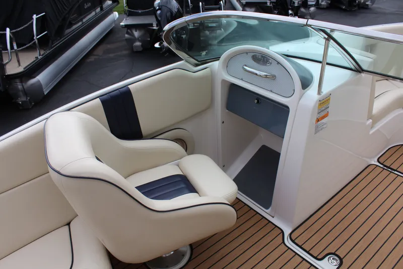 Slide: The Image of Interior of a 2005 Chris-Craft Launch 22 boat with seating and dashboard. - 10