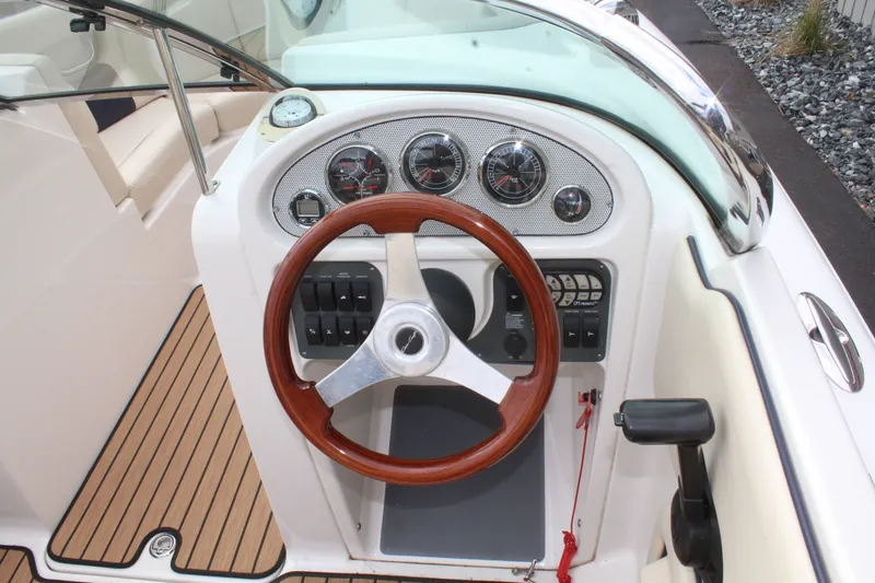 Slide: The Image of 2005 Chris-Craft Launch 22 boat helm with wooden steering wheel. - 12