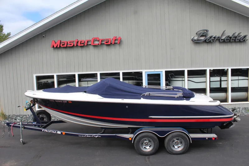 Slide: The Image of 2005 Chris-Craft Launch 22 boat on trailer in front of MasterCraft building. - 3