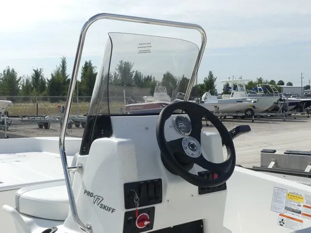 Slide: The Image of 2026 Mako Pro Skiff 17 CC steering console on boat deck. - 15