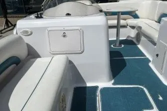 Slide: The Image of 2000 Hurricane FunDeck 198 RE boat interior with blue flooring and white seating. - 13