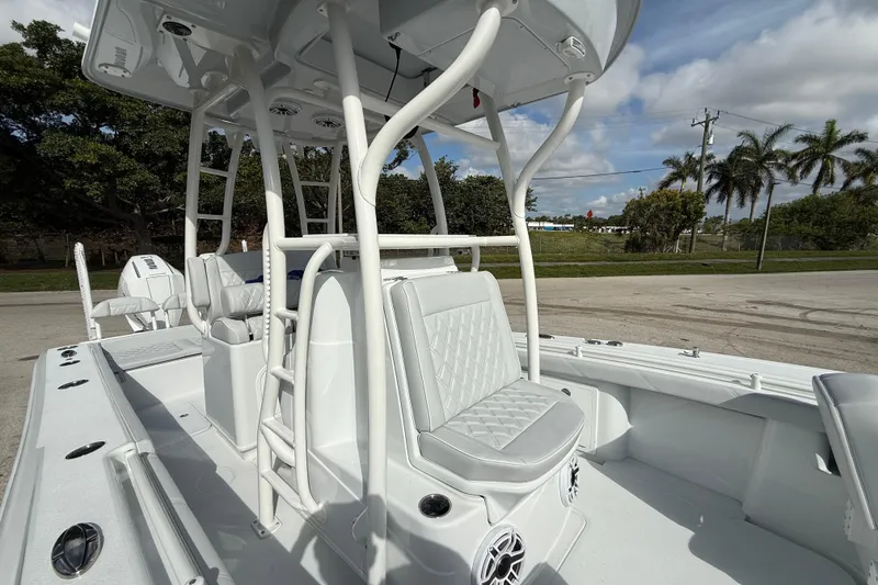 Slide: The Image of 2026 Yellowfin 26 Hybrid boat interior with seating and console, under a clear sky. - 11