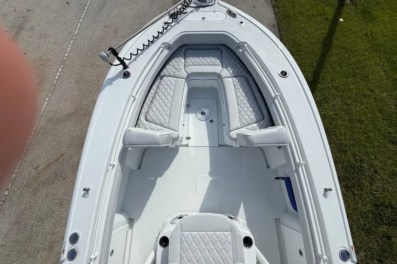 Slide: The Image of 2026 Yellowfin 26 Hybrid boat interior with cushioned seating and clean deck. - 14