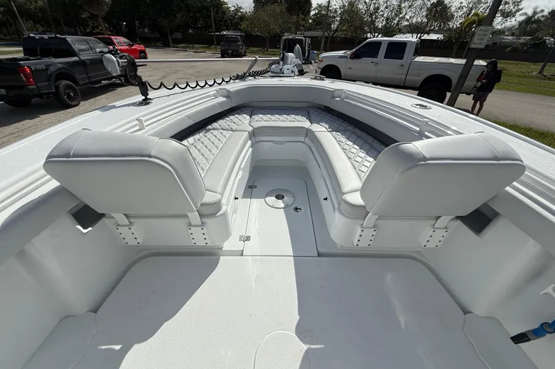 Slide: The Image of 2026 Yellowfin 26 Hybrid boat interior with white seating and spacious deck. - 15