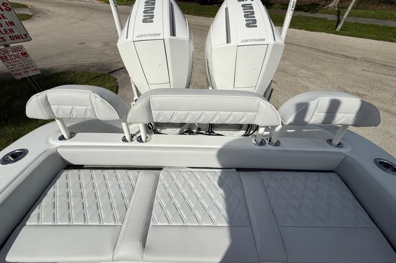 Slide: The Image of 2026 Yellowfin 26 Hybrid boat with white cushioned seating and dual Mercury engines. - 17