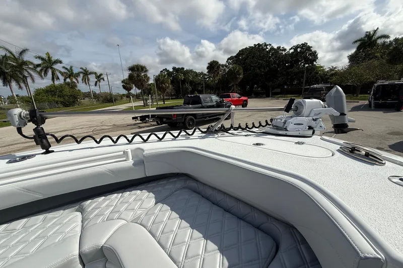 Slide: The Image of 2026 Yellowfin 26 Hybrid boat interior with advanced equipment, parked near palm trees. - 23