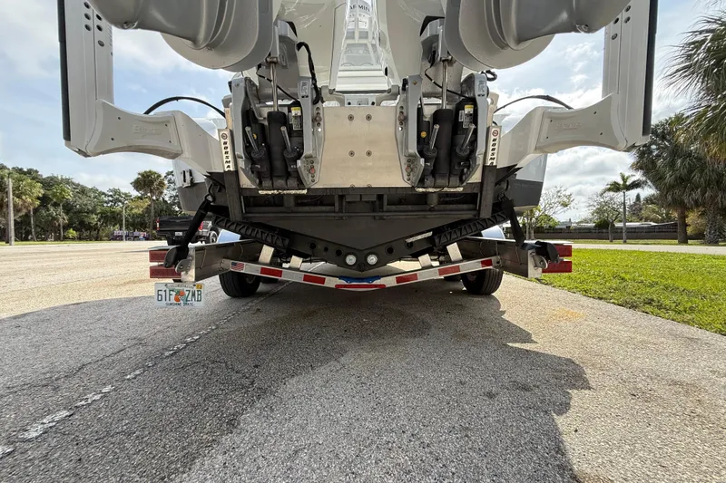 Slide: The Image of Rear view of 2026 Yellowfin 26 Hybrid boat on trailer in sunny outdoor setting. - 26
