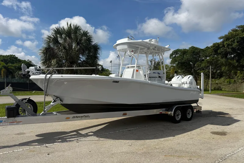 Slide: The Image of 2026 Yellowfin 26 Hybrid boat on trailer, parked outdoors under a clear sky. - 4