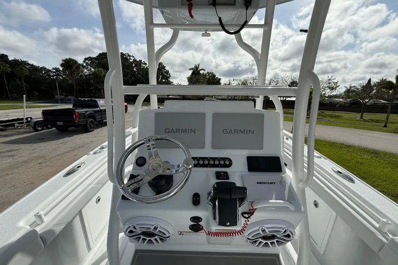 Slide: The Image of 2026 Yellowfin 26 Hybrid boat dashboard with Garmin displays and Mercury controls. - 5