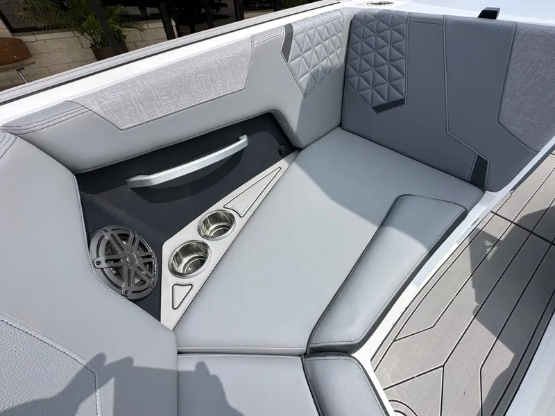Slide: The Image of Interior of 2026 Nautique Super Air Nautique GS22 with speaker and cup holders. - 21