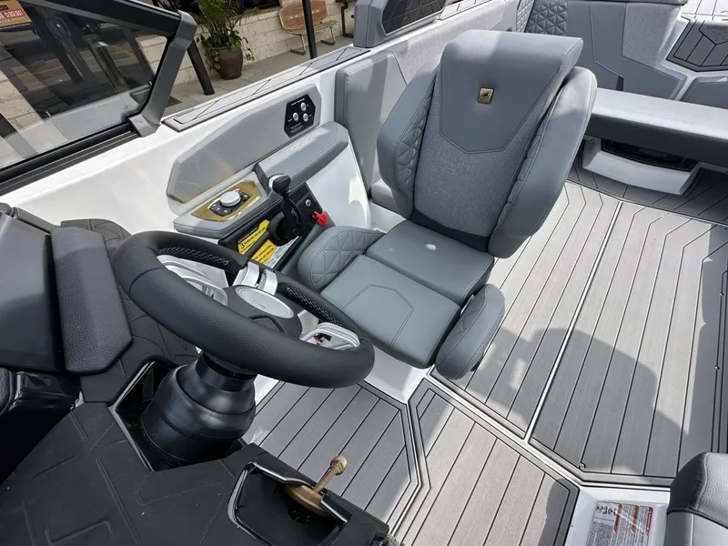 Slide: The Image of Interior of 2026 Nautique Super Air Nautique GS22 with gray seating. - 29
